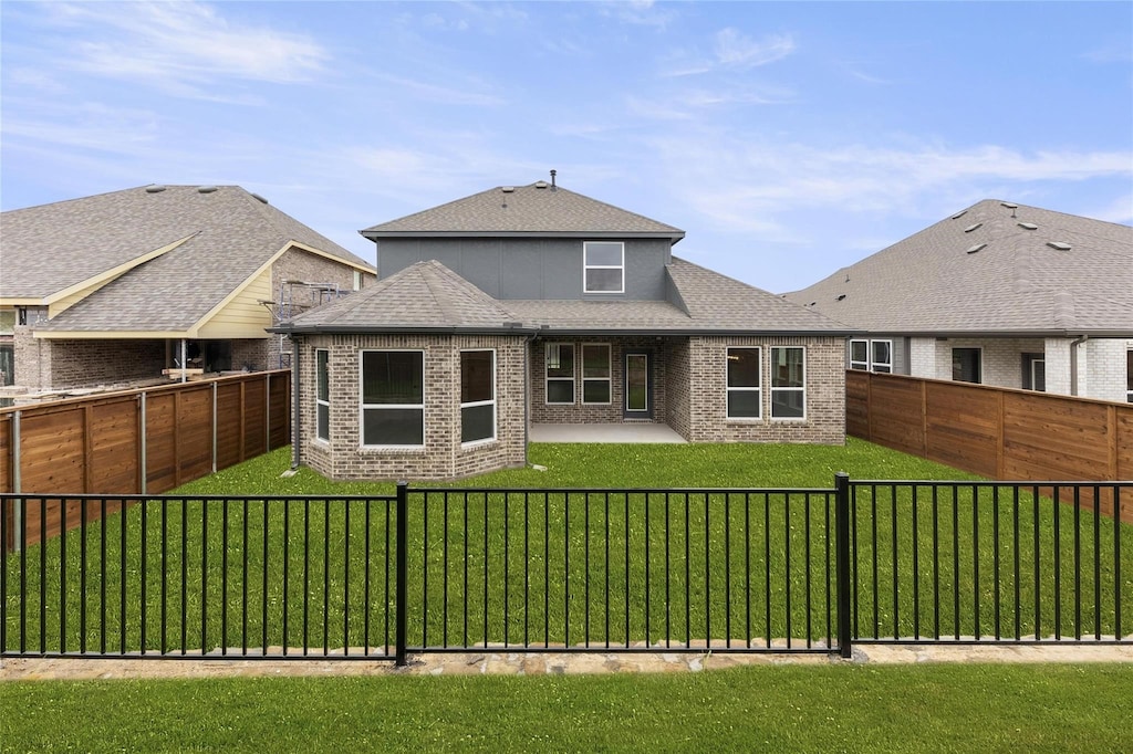 2013 Fall Creek Cv, Mesquite, TX 75181 - rear view of house featuring brick siding, a shingled roof, and a patio area