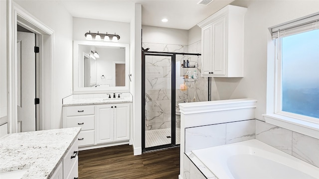 7349 Wildflower Way, Abilene, TX 79602 - full bath with vanity, a garden tub, a marble finish shower, wood finished floors, and recessed lighting