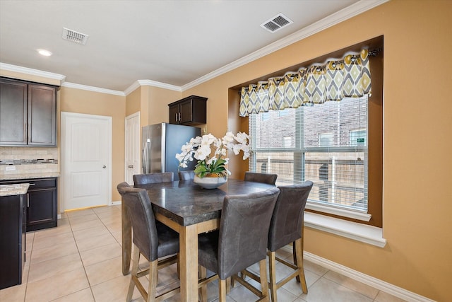 200 Baldwin Dr, Fate, TX 75189 - dining space with ornamental molding, baseboards, and light tile patterned floors