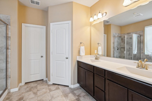 200 Baldwin Dr, Fate, TX 75189 - bathroom with a shower stall, double vanity, and baseboards
