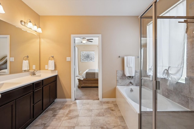 200 Baldwin Dr, Fate, TX 75189 - bathroom featuring ensuite bath, double vanity, a garden tub, and baseboards