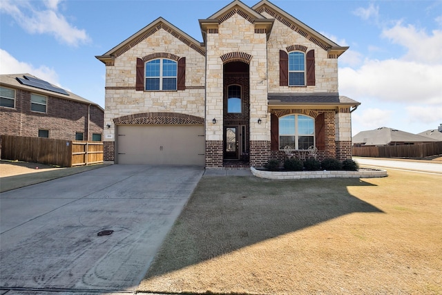 200 Baldwin Dr, Fate, TX 75189 - french country inspired facade with a garage, stone siding, concrete driveway, and brick siding