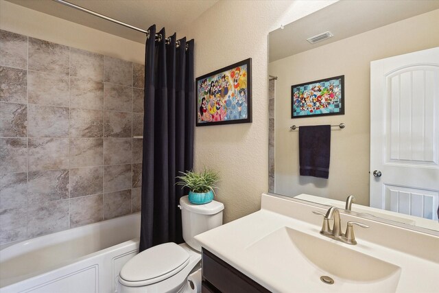 200 Baldwin Dr, Fate, TX 75189 - bathroom with toilet, vanity, shower / bath combo, and a textured wall