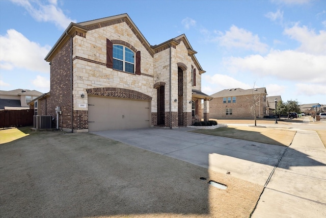 200 Baldwin Dr, Fate, TX 75189 - french provincial home featuring stone siding, driveway, brick siding, and an attached garage