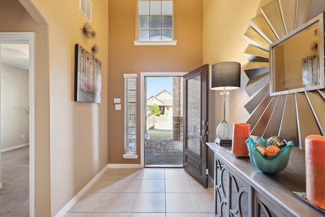 200 Baldwin Dr, Fate, TX 75189 - entrance foyer featuring plenty of natural light, baseboards, light tile patterned flooring, and a towering ceiling