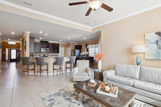 200 Baldwin Dr, Fate, TX 75189 - living area with light tile patterned floors, ornamental molding, ceiling fan, and recessed lighting