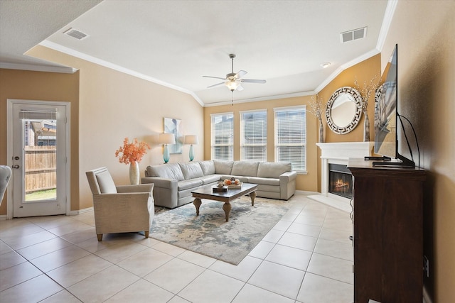 200 Baldwin Dr, Fate, TX 75189 - living room with a ceiling fan, light tile patterned floors, crown molding, a glass covered fireplace, and baseboards
