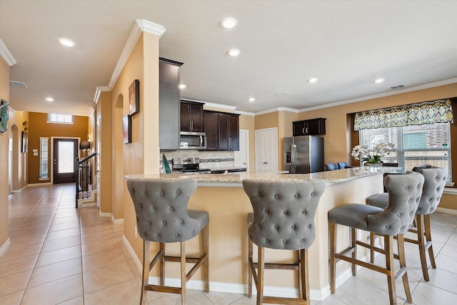 200 Baldwin Dr, Fate, TX 75189 - kitchen featuring stainless steel appliances, plenty of natural light, recessed lighting, light tile patterned floors, and crown molding