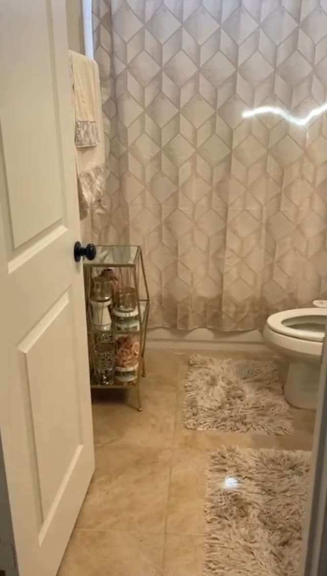 1301 Cold Stream Dr, Wylie, TX 75098 - bathroom with toilet, a shower with shower curtain, and tile patterned flooring