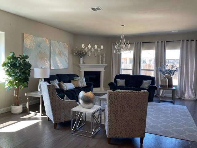 1301 Cold Stream Dr, Wylie, TX 75098 - living area featuring plenty of natural light, wood finished floors, and a fireplace with raised hearth