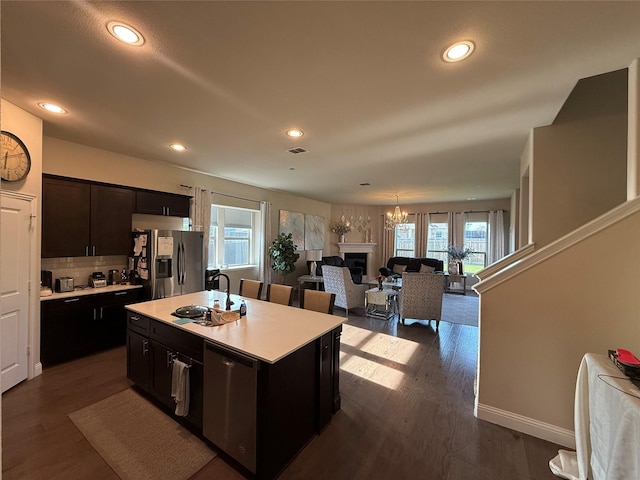 1301 Cold Stream Dr, Wylie, TX 75098 - kitchen with stainless steel fridge with ice dispenser, a sink, light countertops, open floor plan, and dark wood-type flooring