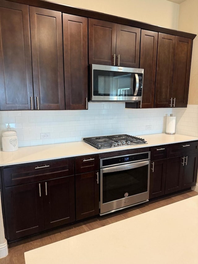1301 Cold Stream Dr, Wylie, TX 75098 - kitchen with stainless steel appliances, backsplash, light countertops, and light wood-style floors