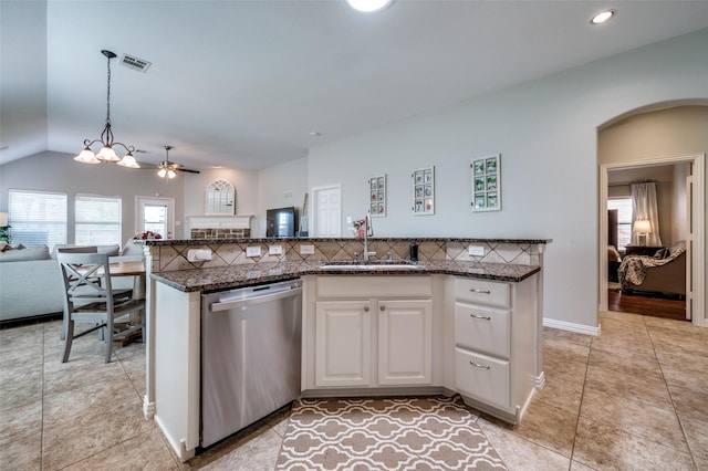 3526 Washington Dr, Frisco, TX 75034 - kitchen featuring stainless steel dishwasher, a sink, arched walkways, white cabinetry, and open floor plan