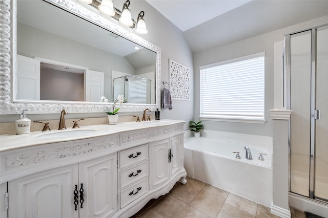 3526 Washington Dr, Frisco, TX 75034 - full bathroom with vaulted ceiling, a shower stall, double vanity, a bath, and tile patterned flooring