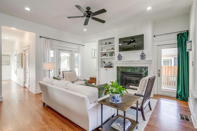 2913 Willing Ave, Fort Worth, TX 76110 - living room featuring ceiling fan, baseboards, light wood-style flooring, a tile fireplace, and recessed lighting