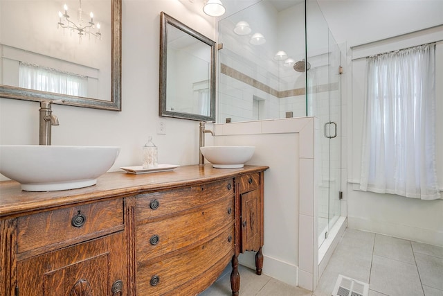 2913 Willing Ave, Fort Worth, TX 76110 - full bath with double vanity, a shower stall, tile patterned flooring, and a chandelier