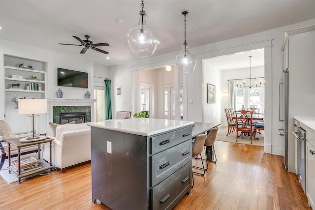 2913 Willing Ave, Fort Worth, TX 76110 - kitchen with a ceiling fan, light countertops, light wood-style flooring, a kitchen island, and recessed lighting