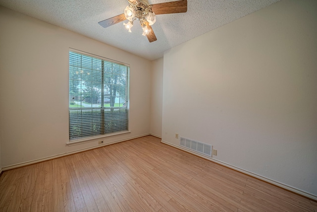 4404 Bentley Dr, Plano, TX 75093 - unfurnished room with a ceiling fan, light wood finished floors, a textured ceiling, and baseboards
