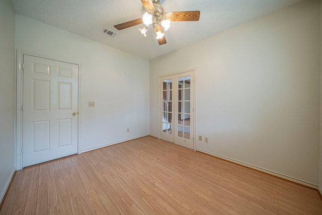 4404 Bentley Dr, Plano, TX 75093 - unfurnished room with light wood-style flooring, ceiling fan, baseboards, a textured ceiling, and french doors