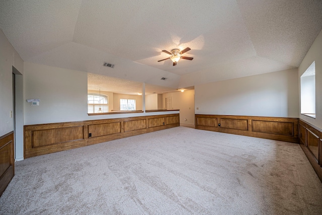 4404 Bentley Dr, Plano, TX 75093 - unfurnished room featuring carpet flooring, lofted ceiling, a textured ceiling, a ceiling fan, and wainscoting