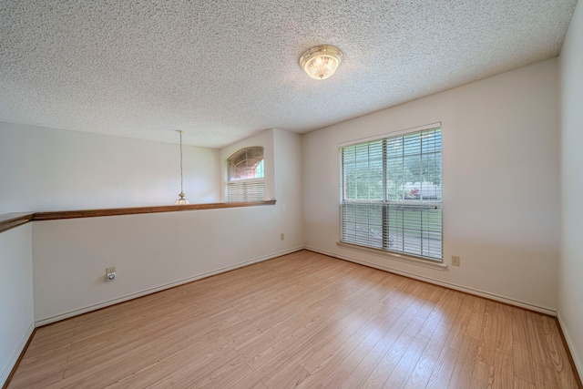 4404 Bentley Dr, Plano, TX 75093 - spare room with wood finished floors, a textured ceiling, and baseboards