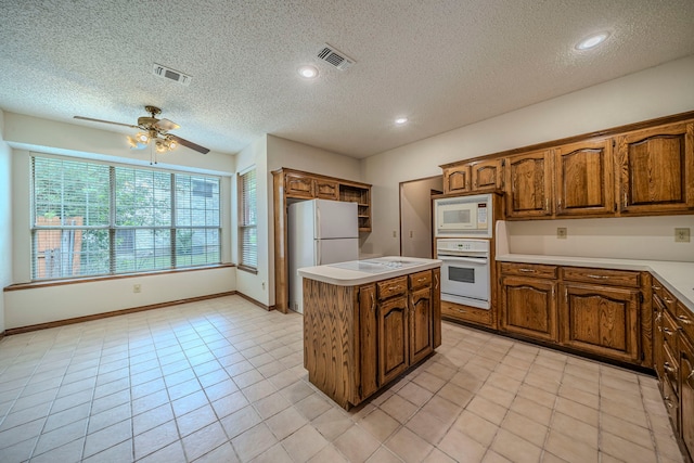 4404 Bentley Dr, Plano, TX 75093 - kitchen featuring white appliances, a kitchen island, a ceiling fan, open shelves, and brown cabinetry