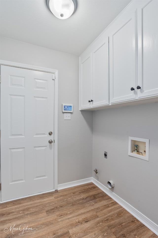 9756 Amblewood Ln, Shreveport, LA 71118 - laundry room featuring electric dryer hookup, cabinet space, baseboards, and light wood-type flooring
