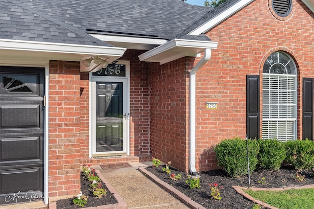 9756 Amblewood Ln, Shreveport, LA 71118 - view of exterior entry with roof with shingles and brick siding