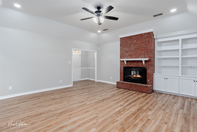 9756 Amblewood Ln, Shreveport, LA 71118 - unfurnished living room featuring ceiling fan, light wood-style flooring, a brick fireplace, baseboards, and lofted ceiling