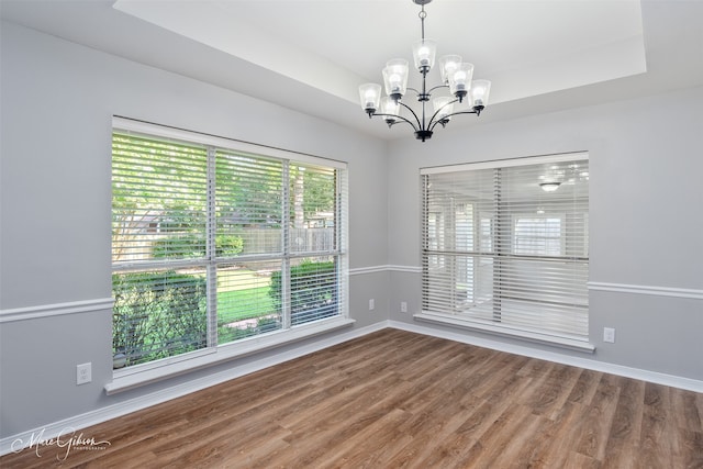 9756 Amblewood Ln, Shreveport, LA 71118 - empty room featuring a chandelier, wood finished floors, and baseboards