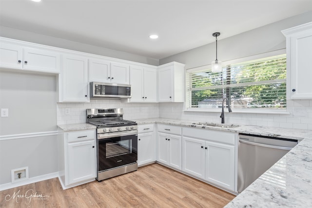 9756 Amblewood Ln, Shreveport, LA 71118 - kitchen with appliances with stainless steel finishes, a sink, white cabinetry, light wood-style floors, and backsplash