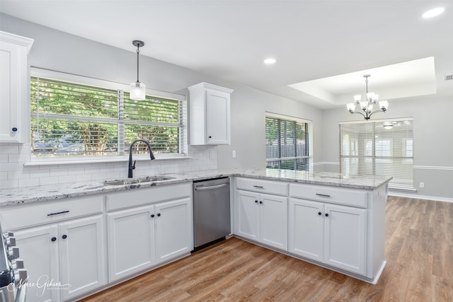 9756 Amblewood Ln, Shreveport, LA 71118 - kitchen featuring stainless steel dishwasher, a sink, a peninsula, a chandelier, and white cabinets
