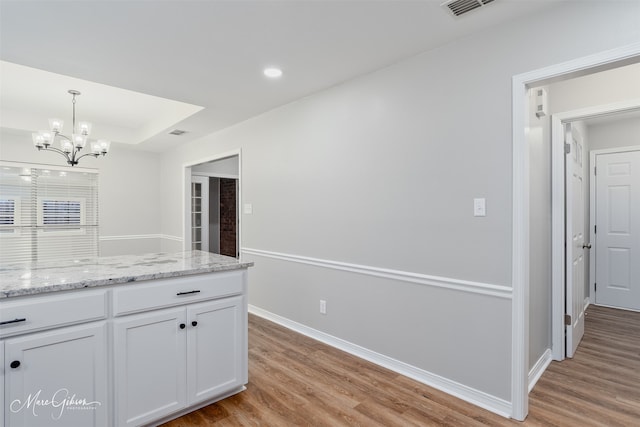 9756 Amblewood Ln, Shreveport, LA 71118 - kitchen featuring a chandelier, light wood-style flooring, white cabinetry, decorative light fixtures, and recessed lighting