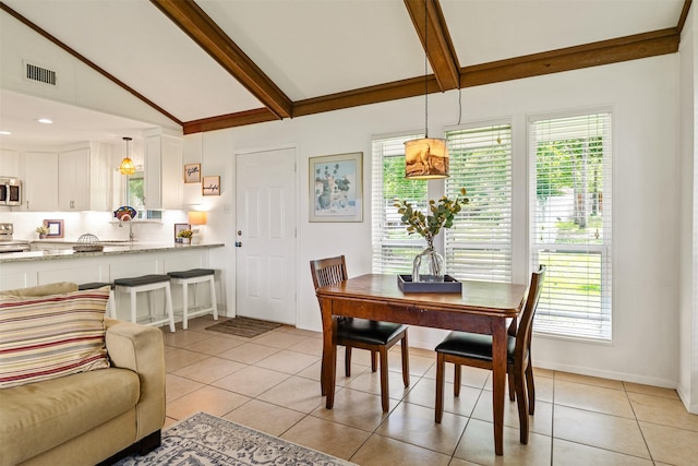 104 Kingsway, Tool, TX 75143 - dining space with light tile patterned floors, beamed ceiling, high vaulted ceiling, and baseboards
