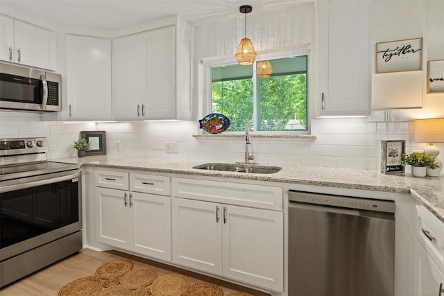 104 Kingsway, Tool, TX 75143 - kitchen featuring stainless steel appliances, a sink, white cabinets, and backsplash