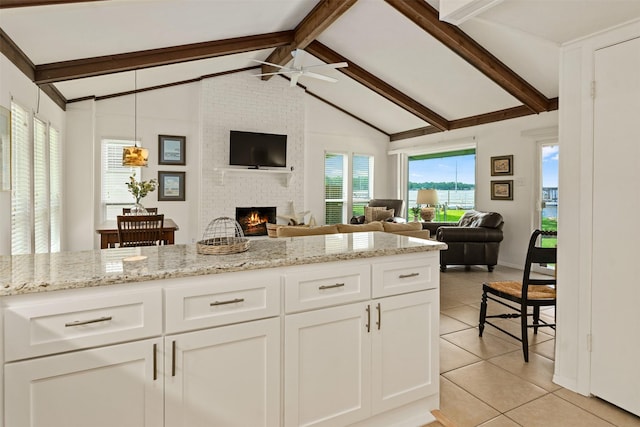104 Kingsway, Tool, TX 75143 - kitchen with ceiling fan, light tile patterned floors, a fireplace, and open floor plan