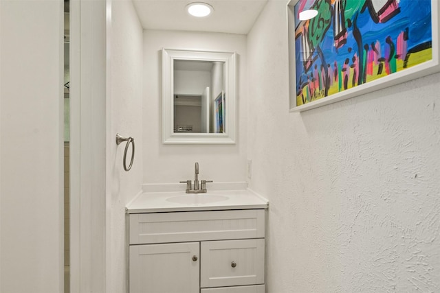 104 Kingsway, Tool, TX 75143 - bathroom featuring vanity and a textured wall