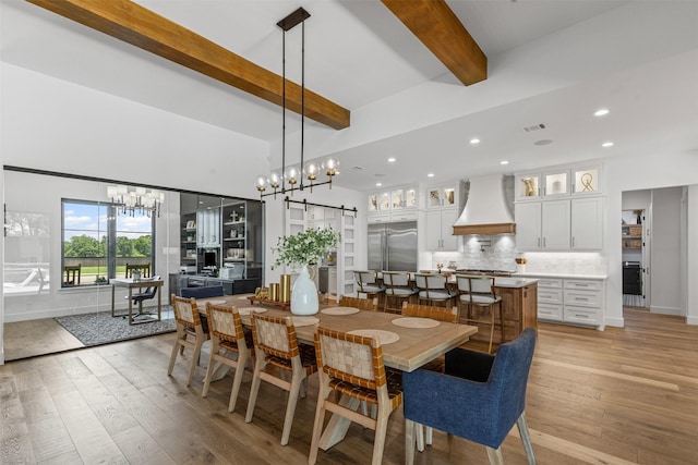 7799 Barber Ranch Rd, Fort Worth, TX 76126 - dining area featuring a barn door, beamed ceiling, a chandelier, light wood finished floors, and recessed lighting
