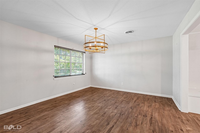 1226 Manor Pl, Shreveport, LA 71118 - spare room with wood finished floors, a chandelier, and baseboards