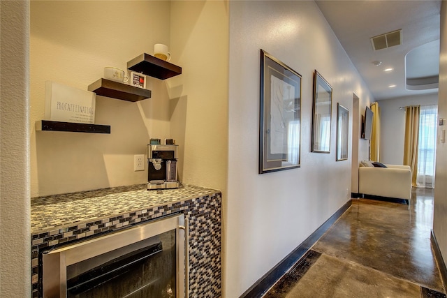 18133 Grandview Dr, Forney, TX 75126 - hall featuring concrete floors, beverage cooler, and baseboards