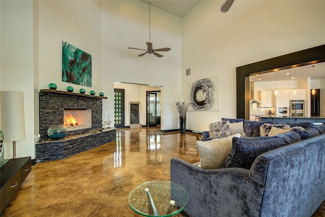 18133 Grandview Dr, Forney, TX 75126 - living area featuring ceiling fan, a towering ceiling, a stone fireplace, and marble tiled floors