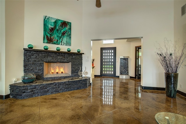 18133 Grandview Dr, Forney, TX 75126 - entryway featuring a towering ceiling, a stone fireplace, and baseboards