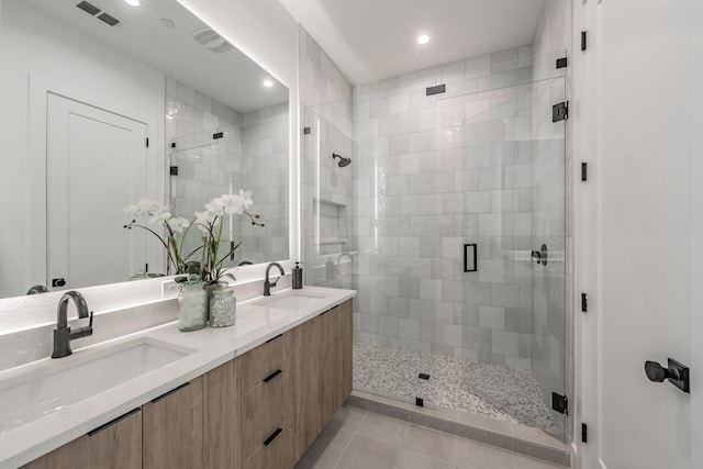 5320 Reiger Ave Unit 101, Dallas, TX 75214 - bathroom featuring a shower stall, double vanity, recessed lighting, and tile patterned flooring