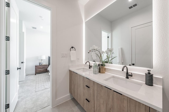 5320 Reiger Ave Unit 101, Dallas, TX 75214 - bathroom featuring double vanity, baseboards, and tile patterned floors