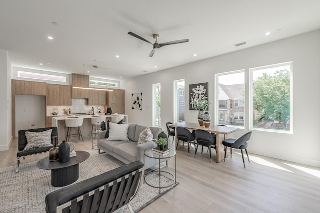 5320 Reiger Ave Unit 101, Dallas, TX 75214 - living area with light wood-style floors, recessed lighting, ceiling fan, and baseboards