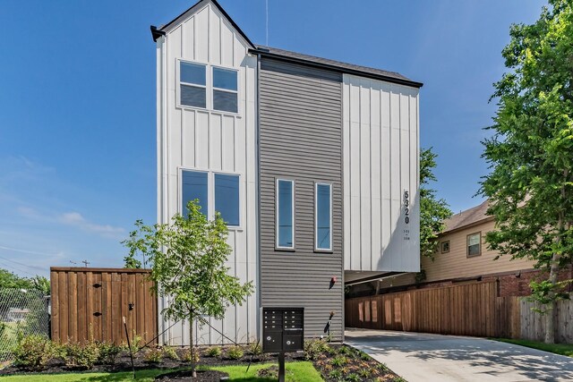 5320 Reiger Ave Unit 101, Dallas, TX 75214 - view of front of property with board and batten siding and concrete driveway