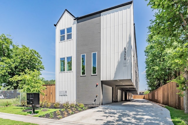 5320 Reiger Ave Unit 101, Dallas, TX 75214 - view of front of home with concrete driveway and board and batten siding