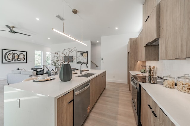 5320 Reiger Ave Unit 101, Dallas, TX 75214 - kitchen featuring stainless steel appliances, modern cabinets, a sink, a center island with sink, and recessed lighting