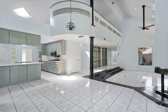 8907 Club Creek Cir, Dallas, TX 75238 - kitchen with light marble finish floors, high vaulted ceiling, gray cabinets, light countertops, and open floor plan