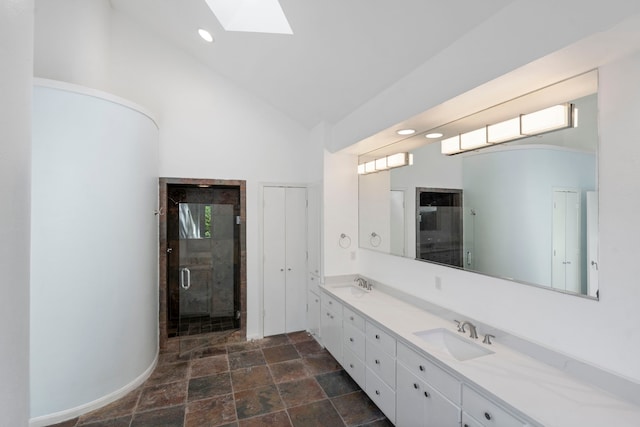 8907 Club Creek Cir, Dallas, TX 75238 - full bath featuring a skylight, double vanity, stone finish floors, high vaulted ceiling, and a shower stall